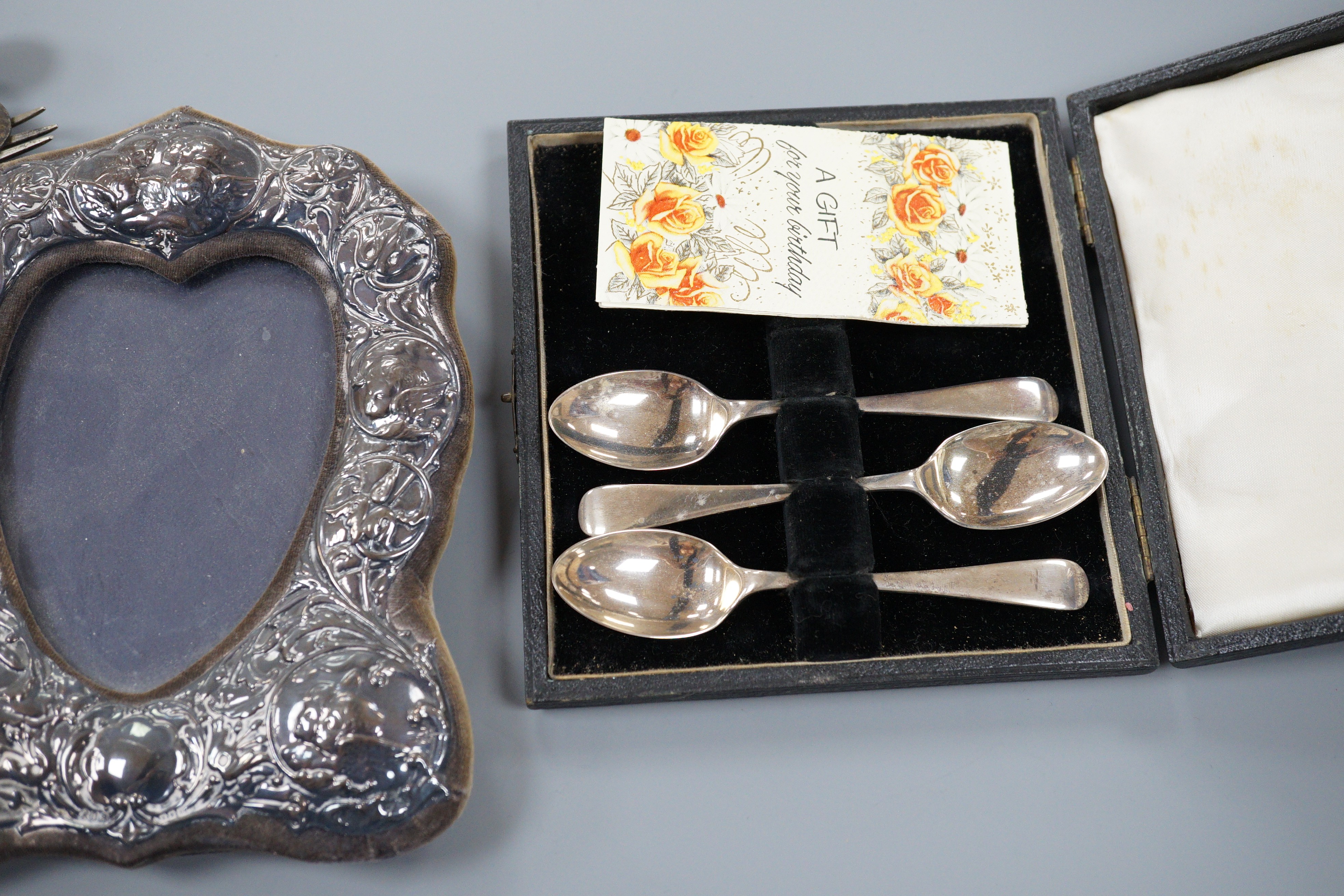 A mixed collection of silver to include cutlery, napkin rings, photograph frame, card cases, small dish, etc.